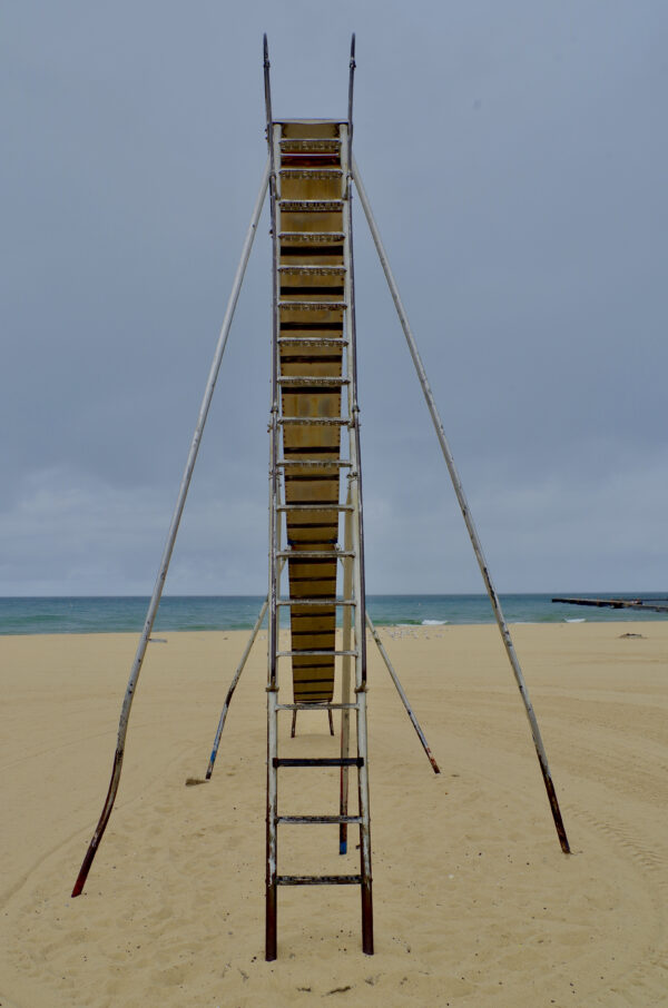 Really, really tall metal slide on Manistee Michigan beach.